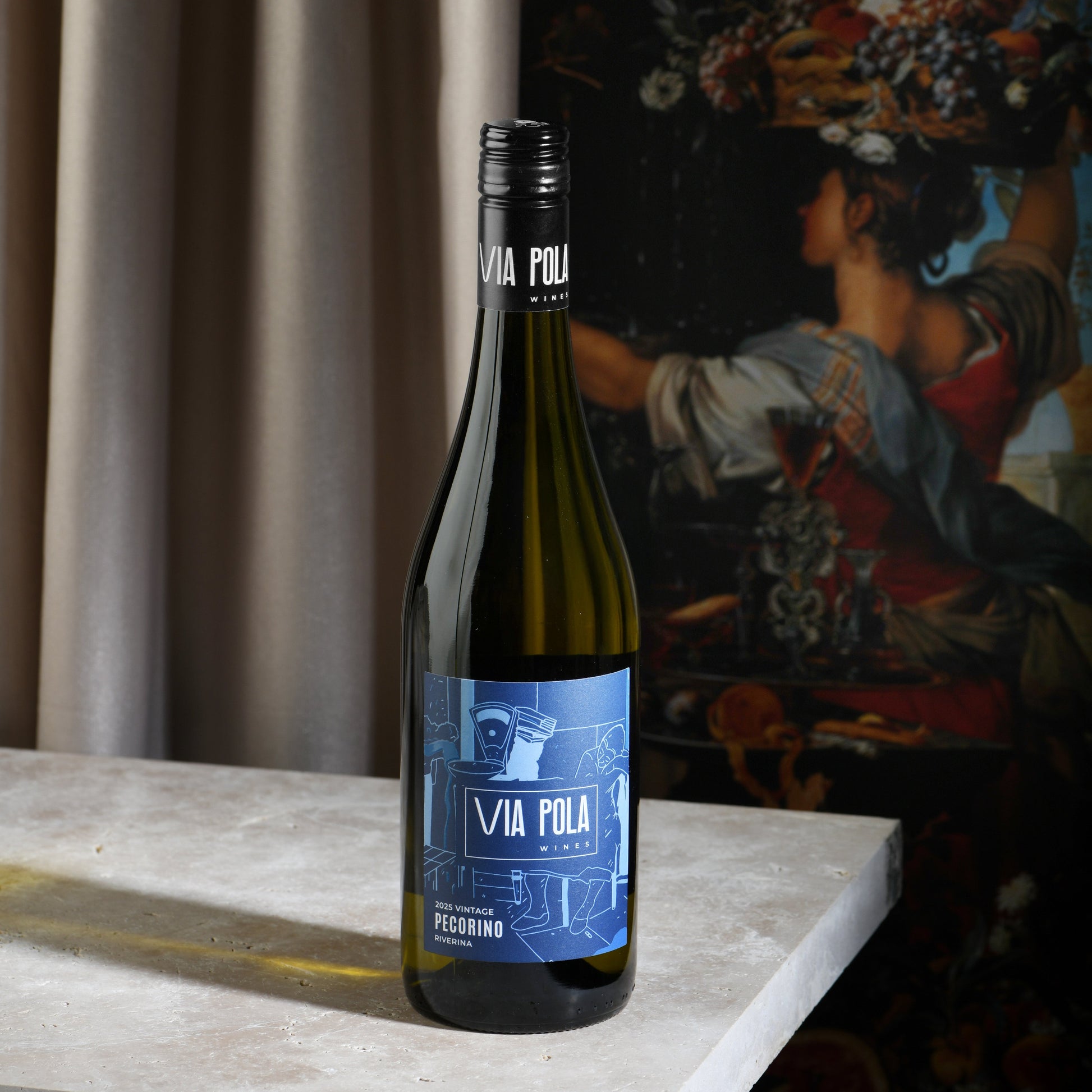 Wine bottle with blue label on a table with a blurred background